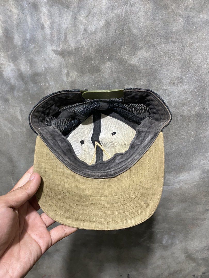 Patagonia Trucker Cap (Category: Caps & Hats) located in Bansud. Submitted by vintagebynitram (Listing ID 1438669349, Image 3). Description: - Patagonia trucker cap - Mesh back and curved brim - "SWAMI'S KIRKLAND, CARDIFF" logo - Snapback closure (adjustable) - Colors: Brown, black, and khaki - Well-worn condition.