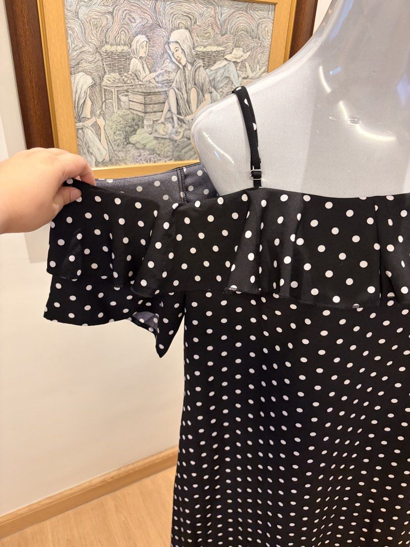 Polka Dot Off-Shoulder Dress (Category: Dresses) located in Quezon City. Submitted by ninas_preloved (Listing ID 1438620227, Image 2). Description: - Black and white polka dot pattern - Off-shoulder design - Ruffled detailing - Adjustable spaghetti straps - Midi length - Suitable for various occasions.