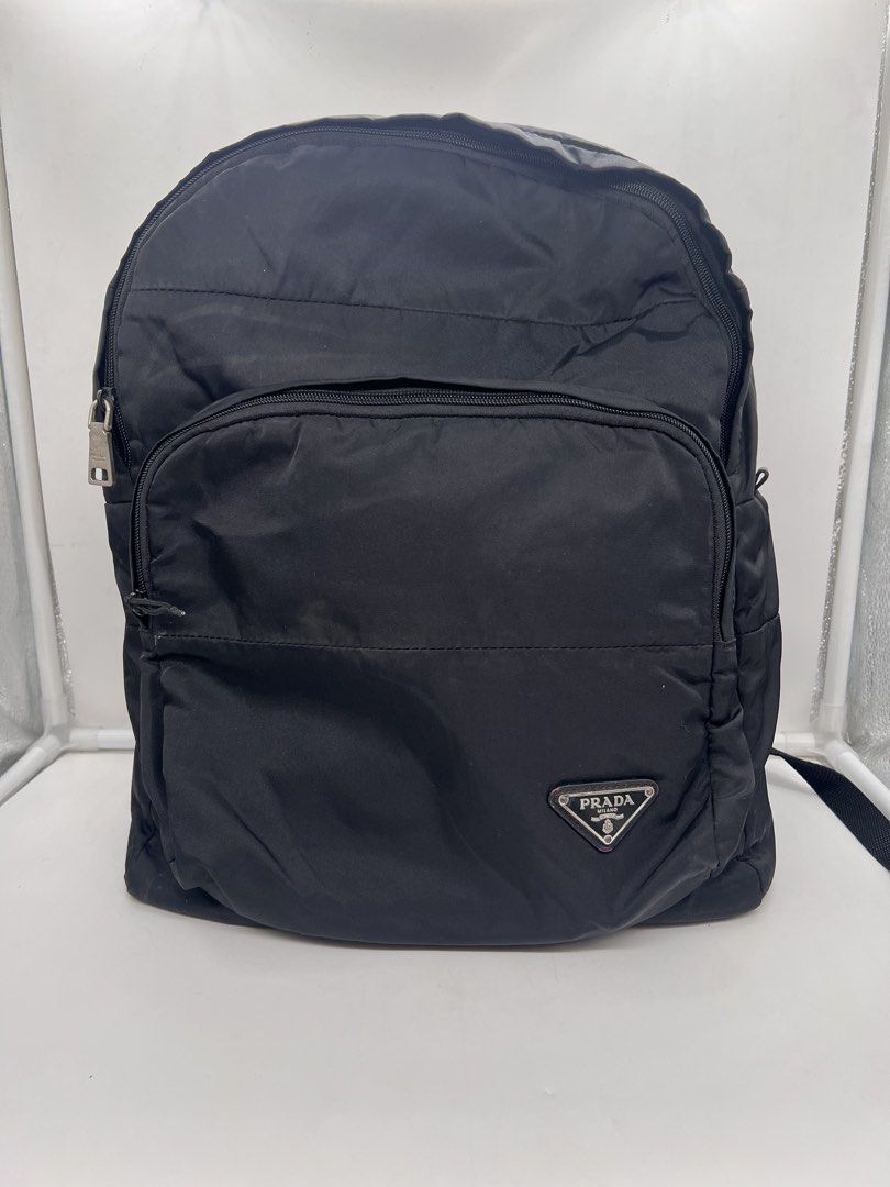 Prada vintage Re-Nylon logo-plaque black backpack (Category: Luxury Bags & Wallets) located in Cavite. Submitted by aellavier (Listing ID 1438506825, Image 1). Description: orig preloved vintage. needs cleaning at the nylon body, color fading at the leather flaps (red yung leather recolored ata to black). 1 missing metal puller, and needs restitching at the lining. lampo zip b&w tag.