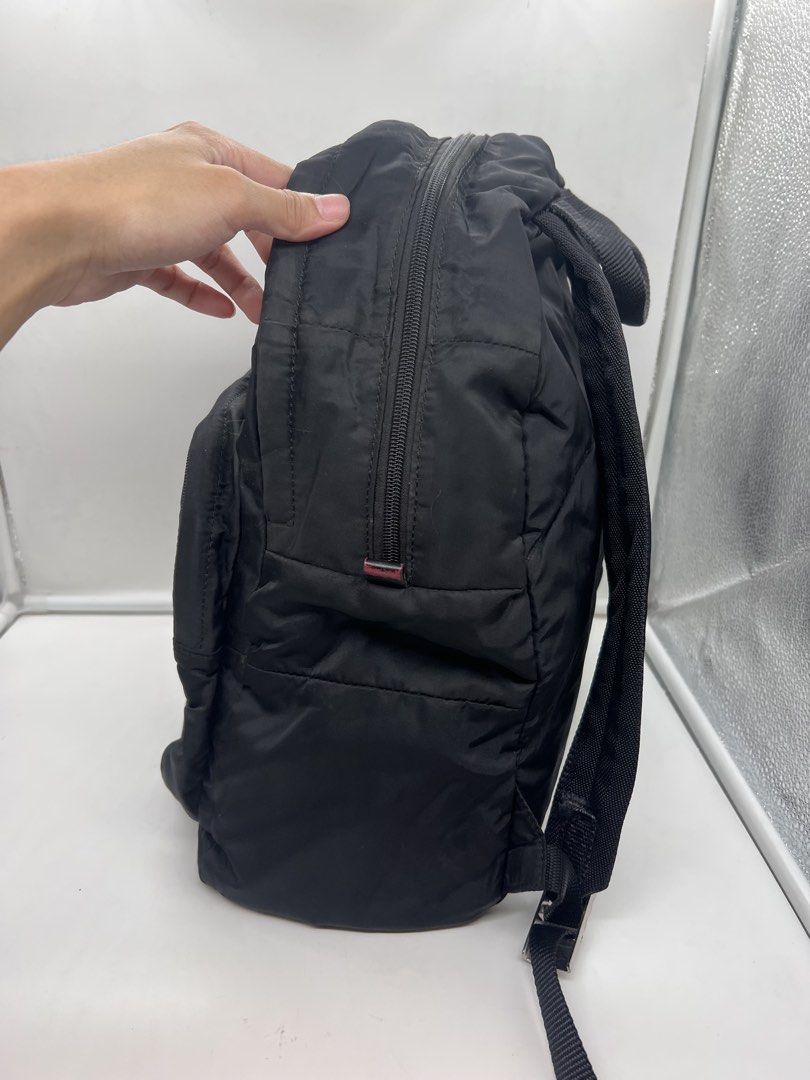 Prada vintage Re-Nylon logo-plaque black backpack (Category: Luxury Bags & Wallets) located in Cavite. Submitted by aellavier (Listing ID 1438506825, Image 2). Description: orig preloved vintage. needs cleaning at the nylon body, color fading at the leather flaps (red yung leather recolored ata to black). 1 missing metal puller, and needs restitching at the lining. lampo zip b&w tag.