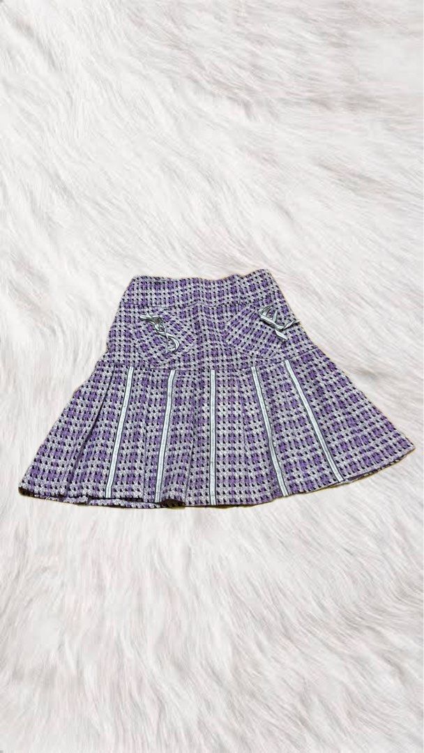 Purple Pleated Skirt with Bows (Category: Skirts) located in Manila. Submitted by iuchan (Listing ID 1438556498, Image 1). Description: - Purple and white checkered pattern - Pleated detailing - Decorative bows on front - White stripes on pleats - Woven fabric - Classic, feminine style.