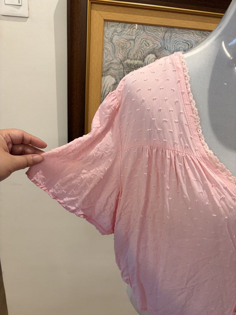 SHEIN Pink Cropped Top with Tie (Category: Blouses) located in Quezon City. Submitted by ninas_preloved (Listing ID 1438598844, Image 3). Description: Cropped top features a delicate pink color and a flattering V-neckline. It has short sleeves and a tie closure at the front. The fabric has a subtle textured pattern. The top is designed with a cropped length, making it a versatile piece for various outfits..