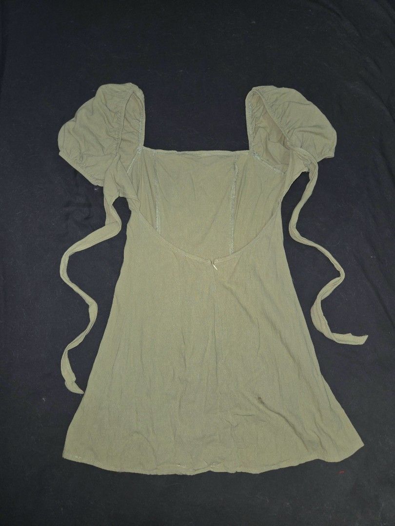 SHEIN Sage Green dress open back (Category: Dresses) located in Manila. Submitted by chii_haru (Listing ID 1438592041, Image 2). Description: - Sage green mini dress - Square neckline - Puff sleeves - Tie-back detail - Zipper closure - Soft knit fabric - Versatile for various occasions Worn Once.