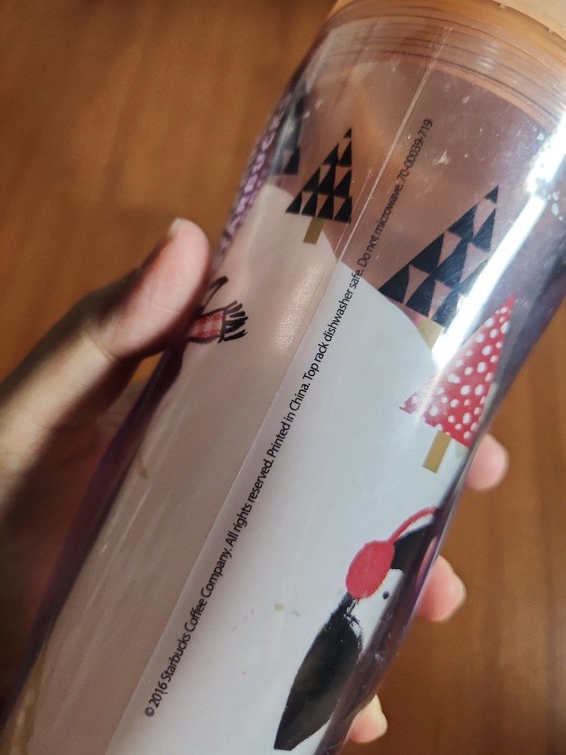 Starbucks Christmas Water Bottle 2016 (Category: Water Bottles & Tumblers) located in Manila. Submitted by jochaaa011 (Listing ID 1438623048, Image 2). Description: - Starbucks Christmas water bottle - Clear body with a festive, colorful illustration - Light orange lid with flip-top closure - Starbucks logo on the bottom - Made in China.
