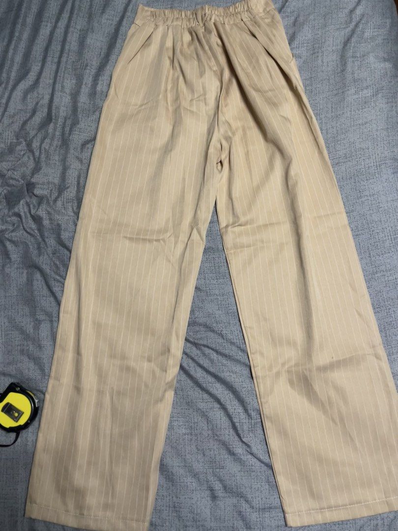 Striped Wide Leg Pants (Category: Other Bottoms) located in Quezon City. Submitted by listless32 (Listing ID 1438691130, Image 2). Description: Waist 22 to 29 L is 39.5 Light beige wide-leg pants with vertical stripes. High-waisted with button closure and pleats. Elastic waistband at the back. Lightweight and perfect for casual wear..