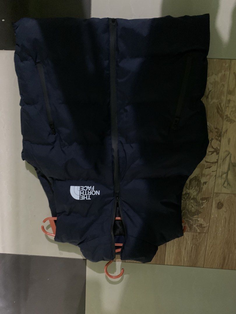The North Face Puffer Vest (Category: Vests) located in Manila. Submitted by stashflip (Listing ID 1438689370, Image 2). Description: - Navy blue The North Face puffer vest - Full-zip closure - Two zippered hand pockets - High collar - The North Face logo on chest - Well-padded for warmth - Sleeveless design.