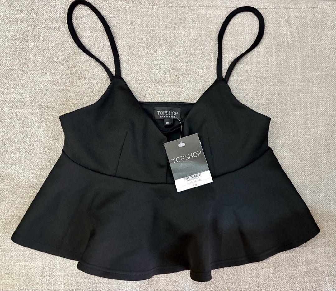 Topshop Black Peplum Top (Category: Sleeveless) located in Pasig City. Submitted by mm__ks888 (Listing ID 1438515090, Image 1). Description: - Brand: Topshop - Style: Peplum top - Features: Spaghetti straps, V-neck - Condition: New with tags.