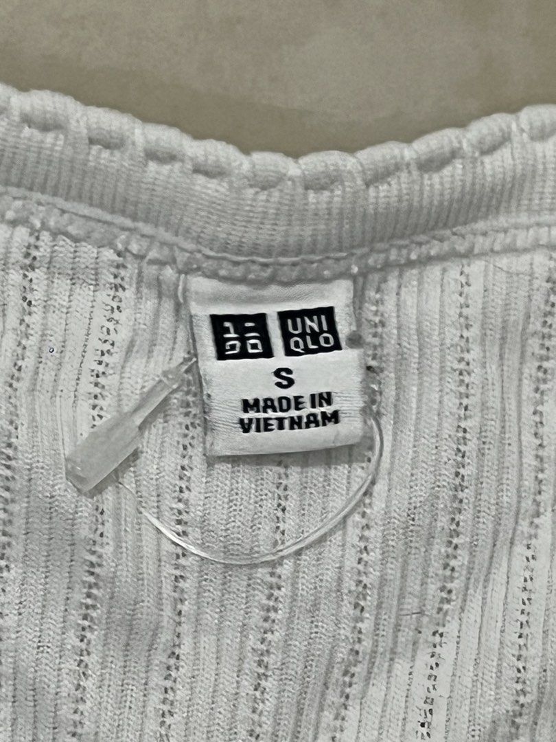 Uniqlo Ribbed Crop Top - Size S (Category: Shirts) located in Manila. Submitted by gemini.river (Listing ID 1438530339, Image 3). Description: - Uniqlo white ribbed crop top - Size: S - Features a scoop neckline - Button-down front - Short sleeves - Fitted silhouette - Made in Vietnam - Perfect for casual wear.
