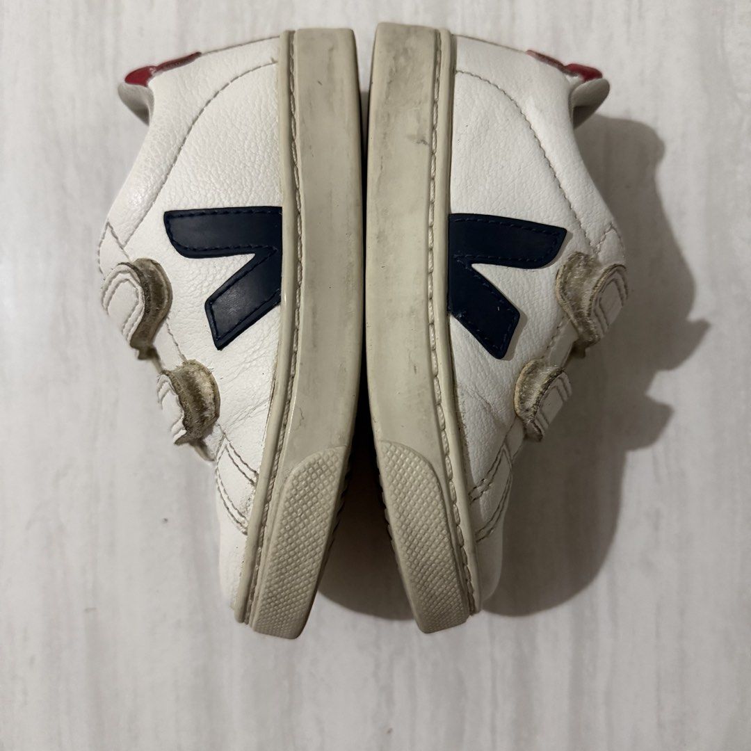 Veja Kids Velcro Sneakers (Category: Babies & Kids Fashion) located in Batangas. Submitted by lovedbyjoycee (Listing ID 1438689618, Image 3). Description: - Veja kids sneakers - White with navy blue logo and red accents - Velcro closure - Size: EU 25, US 8.5, UK 8, 15.5 cm - Amazonian rubber soles - Just needs cleaning.