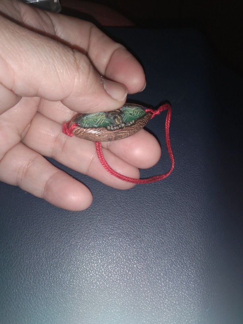 Vintage Oval Pendant Bracelet (Category: Bracelets) located in Quezon City. Submitted by eidorableshop (Listing ID 1438621976, Image 2). Description: - Vintage bracelet - Oval pendant with intricate designs - Copper-colored frame with green and other colored details - Red string - Dark back of pendant - Unique, vintage style.