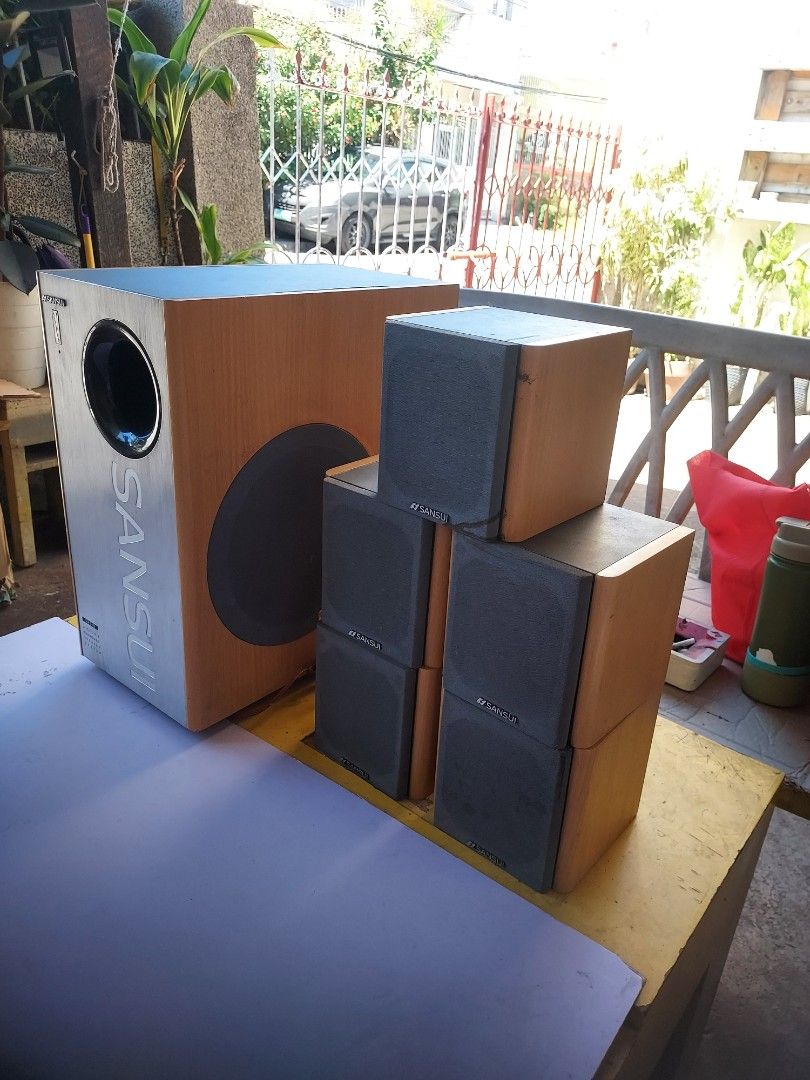 Vintage Sansui Surround Speaker System Model SHT 10 (Category: Soundbars, Speakers & Amplifiers) located in Muntinlupa City. Submitted by ediethzky (Listing ID 1438524368, Image 2). Description: - Sansui speaker system NO REMOTE - Includes subwoofer and five satellite speakers - Subwoofer features a large circular port and Sansui logo - Satellite speakers are square-shaped - Wooden finish - Includes all necessary connection cables - Subwoofer has