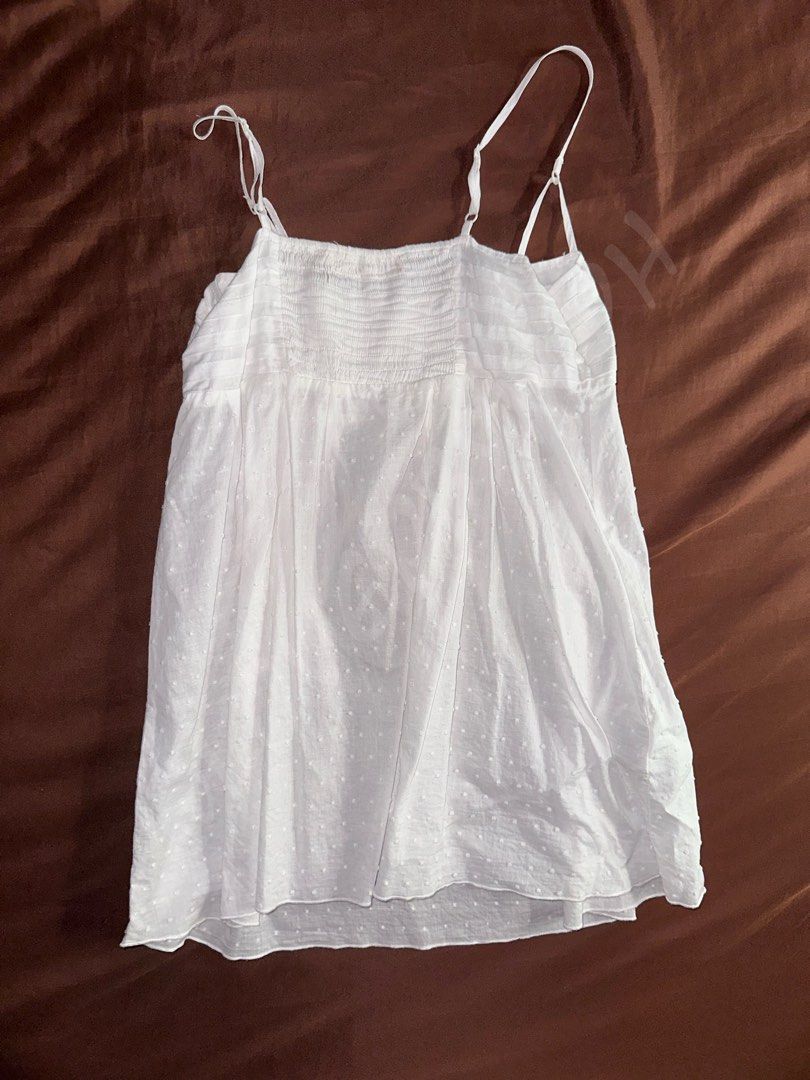 White Sheer Polka Long Peplum Spaghetti Strap Cami Top (Category: Sleeveless) located in Taguig. Submitted by lovedbym.sell (Listing ID 1438564778, Image 2). Description: Fabric is a bit sheer, can be worn as summer oufit. Just wear inner white tube! Bust: 32 in Length (w/o strap): 20 in RFS: decluttering.