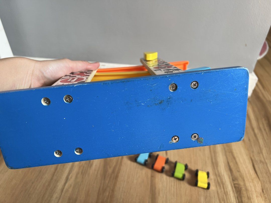 Wooden Race Track Toy (Category: Educational & Learning Toys) located in Quezon. Submitted by smallville.ph (Listing ID 1438563199, Image 3). Description: - Wooden race track with numbered lanes - Includes colorful cars (blue, orange, green, yellow) - Features a checkered flag design - Made of wood - Ideal for young children.
