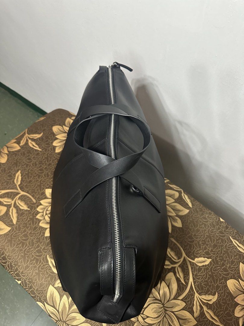 Zara Duffle Travel Bag - Black (Category: Luxury Bags & Wallets) located in Batangas. Submitted by jim2621 (Listing ID 1438507630, Image 3). Description: - Zara Duffle Travel Bag - Black - Zippered closure - Two top handles - Interior zippered pocket - Smooth, leather-like material - Spacious design - Ideal for travel or everyday use.