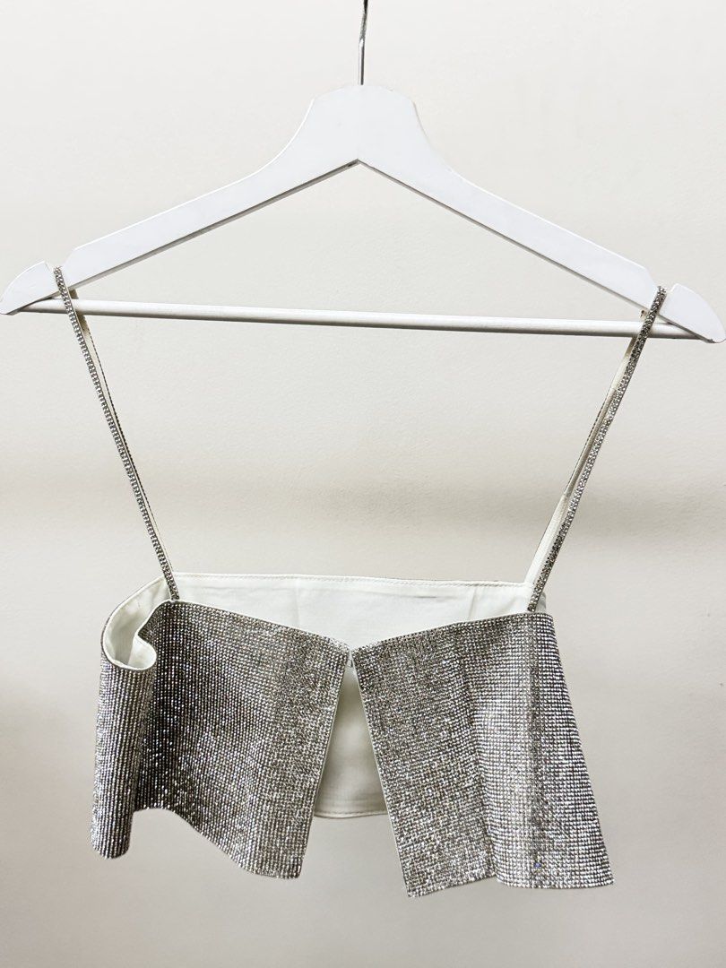 Zara Rhinestone Crop Top XS (Category: Sleeveless) located in Paranaque City. Submitted by panmakes (Listing ID 1438637229, Image 2). Description: - Zara rhinestone crop top - Size: XS - Features delicate spaghetti straps - Unique open front design - White inner lining - Made in Morocco - Ideal for nights out and special events.