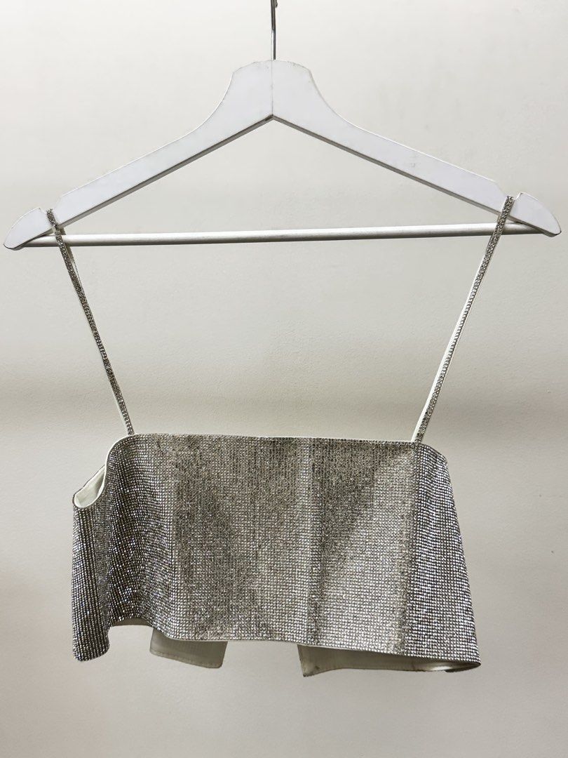 Zara Rhinestone Crop Top XS (Category: Sleeveless) located in Paranaque City. Submitted by panmakes (Listing ID 1438637229, Image 1). Description: - Zara rhinestone crop top - Size: XS - Features delicate spaghetti straps - Unique open front design - White inner lining - Made in Morocco - Ideal for nights out and special events.