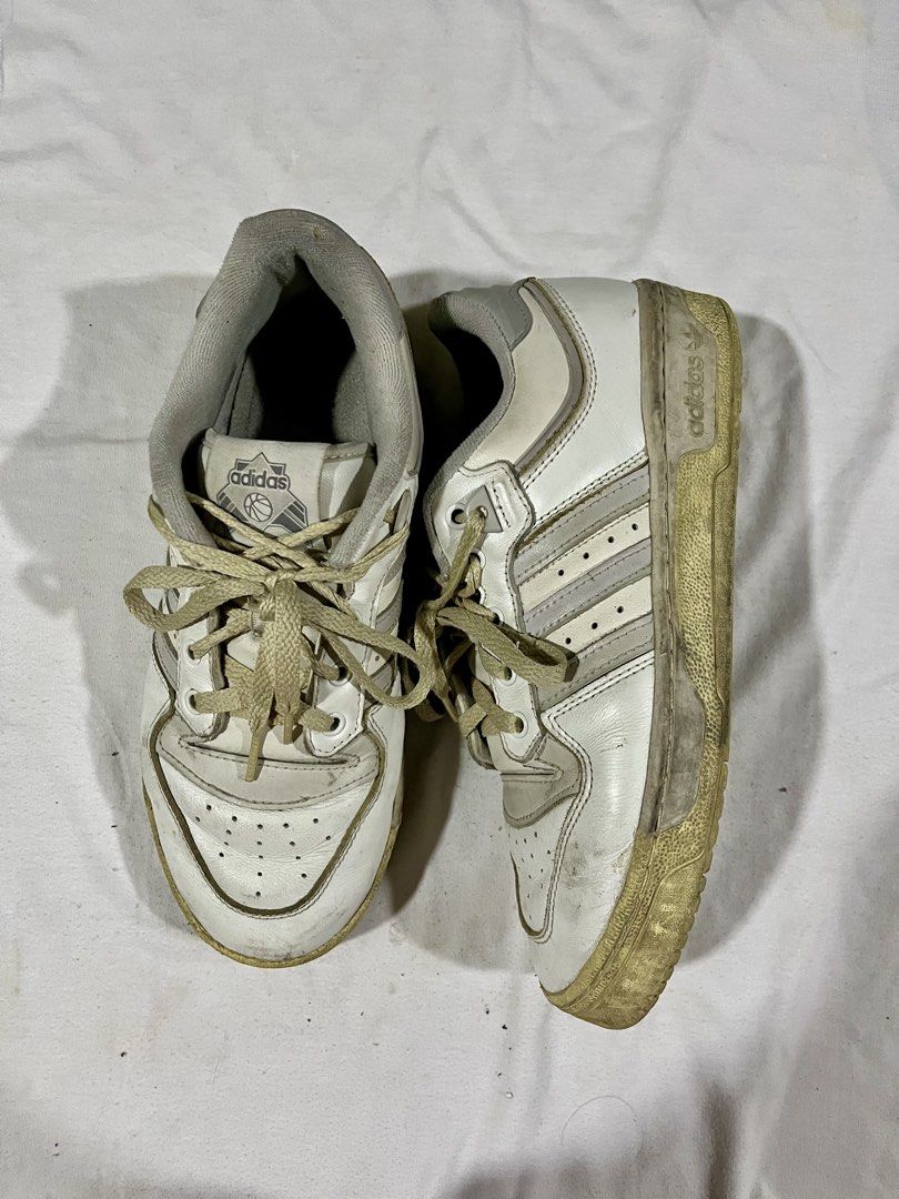 Adidas Rivalry Low Basketball Shoes (Category: Sneakers) located in Caloocan City. Submitted by acmat1997-06485 (Listing ID 1438863992, Image 1). Description: - Adidas Rivalry Low basketball shoes - Color: White with grey accents - Adidas logo on tongue and side - Lace-up closure - Classic design.