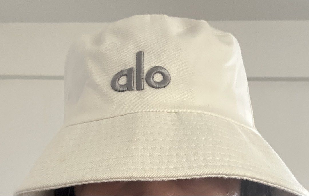 ALO YOGA Weekender Bucket Hat (Category: Hats & Beanies) located in Manila. Submitted by manifestd. (Listing ID 1438747030, Image 2). Description: ALO YOGA Weekender Bucket Hat ✔️Cream, never worn (not my style, given as a gift, rfs: decluttering) ✔️Unisex, free size, classic bucket hat design ✔️Embroidered ALO logo ✔️Lalamove/J&T ready *also listed on my main acct archivedpieces.