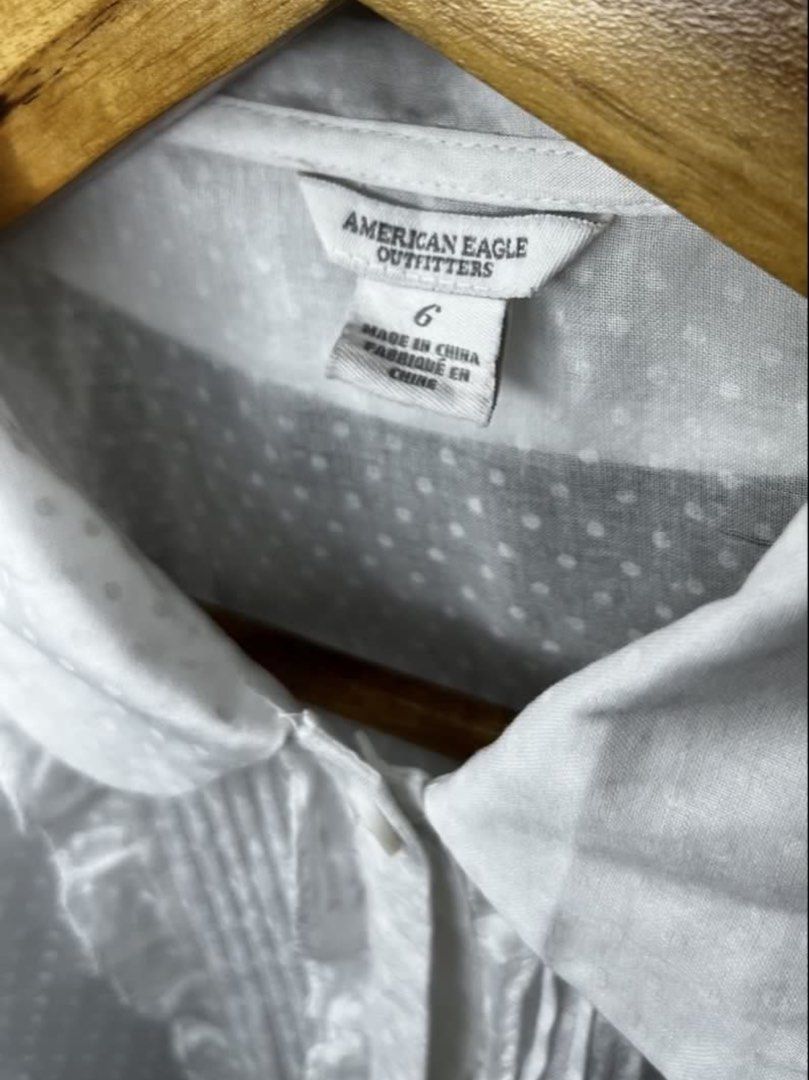 American Eagle Outfitters White Polka Dot Blouse (Category: Blouses) located in Malabon City. Submitted by igigs (Listing ID 1438756966, Image 2). Description: - American Eagle Outfitters blouse - White with polka dot pattern - Ruffled detailing - Short sleeves - Collared neckline - Button-down closure - Size 6 - Made in China.