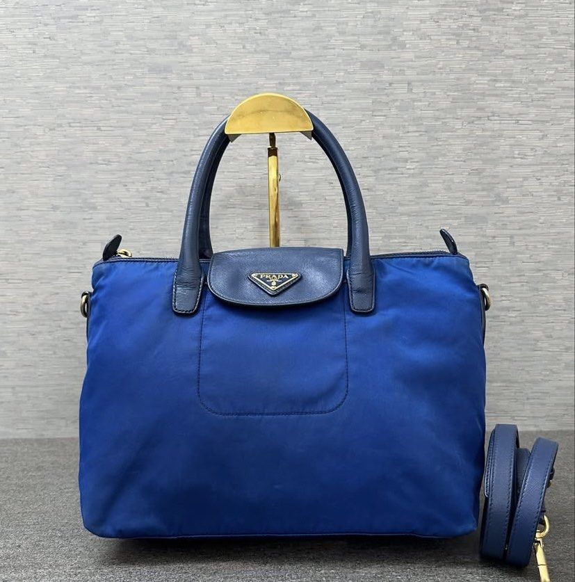 SALE! Authentic Prada Blue Nylon Crossbody 2 way with entrupy (Category: Luxury Bags & Wallets) located in Santa Rosa. Submitted by happydays__ (Listing ID 1438739307, Image 1). Description: - Prada handbag - Vibrant blue nylon exterior - Leather accents - Top handle - Detachable PRADA shoulder strap - Front pocket - Gold-tone hardware Really nice bag! Guaranteed authentic. With Entrupy cert LBC or Lalamove Pick up: South Forbes near Nuvali BPI o