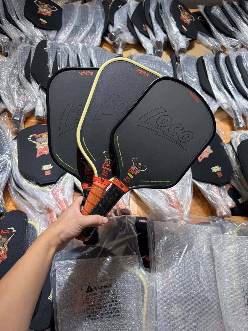 BREAD AND BUTTER LOCO PADDLE (Category: Racket and Ball Sports) located in Bulacan. Submitted by parapapa (Listing ID 1438766809, Image 1). Description: Bread & Butter Loco Paddle (Elongated / Hybrid) 16mm thick Gen 4 foam-core pickleball paddle featuring a T-700 raw carbon fiber face with a fiberglass layer for increased pop. Inclusion: 1 paddle, 1 overgip, 1 edge tape, paddle case, sticker, cup holder. Shipping via J&T wrap in bubble and place 