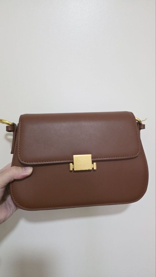 Brown Shoulder Bag with Gold Hardware (Category: Luxury Bags & Wallets) located in Manila. Submitted by abigailedi49523 (Listing ID 1438827226, Image 1). Description: - Genuine Leather - Brown shoulder bag - Rectangular shape - Flap closure - Gold-colored hardware - Single shoulder strap - Smooth material - Suitable for various occasions.