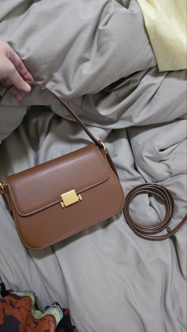 Brown Shoulder Bag with Gold Hardware (Category: Luxury Bags & Wallets) located in Manila. Submitted by abigailedi49523 (Listing ID 1438827226, Image 3). Description: - Genuine Leather - Brown shoulder bag - Rectangular shape - Flap closure - Gold-colored hardware - Single shoulder strap - Smooth material - Suitable for various occasions.