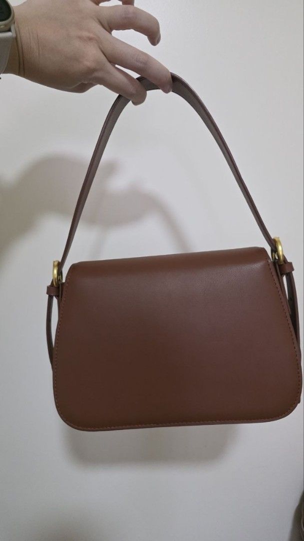 Brown Shoulder Bag with Gold Hardware (Category: Luxury Bags & Wallets) located in Manila. Submitted by abigailedi49523 (Listing ID 1438827226, Image 2). Description: - Genuine Leather - Brown shoulder bag - Rectangular shape - Flap closure - Gold-colored hardware - Single shoulder strap - Smooth material - Suitable for various occasions.
