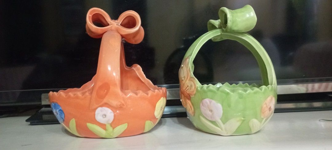 Butterfly Ceramic Wall Planters (Category: Wall Decor) located in Manila. Submitted by cool_niacene15 (Listing ID 1438797979, Image 2). Description: - Set of two ceramic wall planters - Features butterfly and floral designs - Colors: Green and orange - Design: Bow-shaped base and scalloped rim - Ideal for small plants or decorative items - Adds a whimsical touch to any space - 13 x 14 x 15 cm .