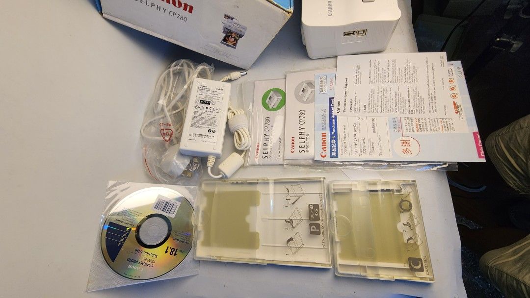 Canon SELPHY CP780 Photo Printer (Category: Printers, Scanners & Copiers) located in Baguio. Submitted by chiechie1234 (Listing ID 1438760865, Image 2). Description: - Canon SELPHY CP780 photo printer - Includes original box, power adapter, and manuals - Comes with CD-ROM and print cartridge trays - White color - Perfect for instant prints.