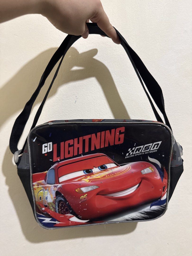 Cars Lightning McQueen Messenger Bag (Category: Luxury Bags & Wallets) located in Manila. Submitted by klayyzhidalgoo (Listing ID 1438806133, Image 1). Description: - Lightning McQueen messenger bag - Black shoulder strap - Zippered main compartment - Interior lined with light-colored material - Features 'GO LIGHTNING' and 'RSD Racing Sports Network' graphics.