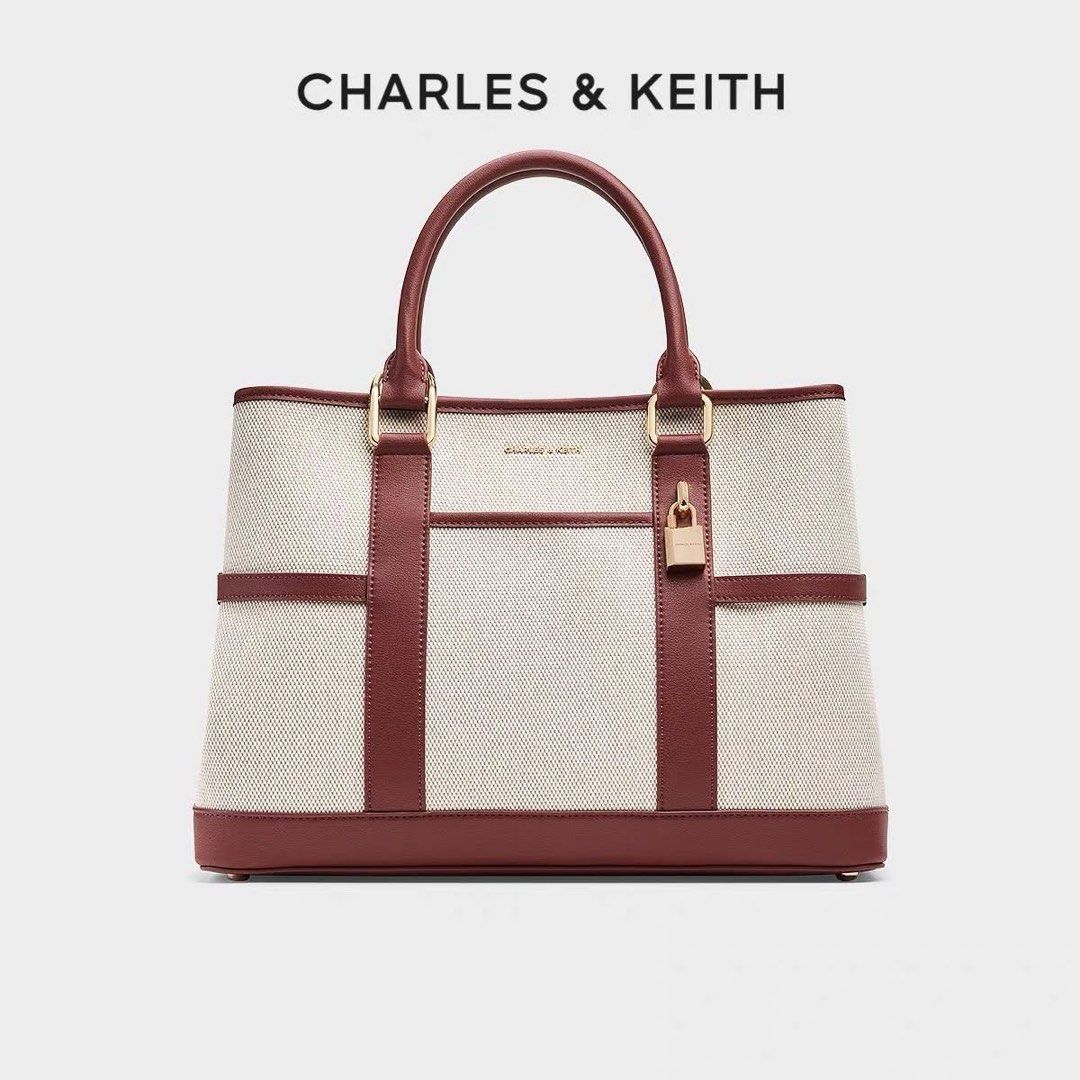 Charles & Keith Top Handle Bag (Category: Luxury Bags & Wallets) located in Manila. Submitted by rcwluxx (Listing ID 1435674413, Image 3). Description: - Charles & Keith top handle bag - Padlock detail - Available colors: Black, Brown, Cream/Burgundy - Structured design - Detachable strap included - Rectangular shape - Gold-tone hardware - Small logo detail.