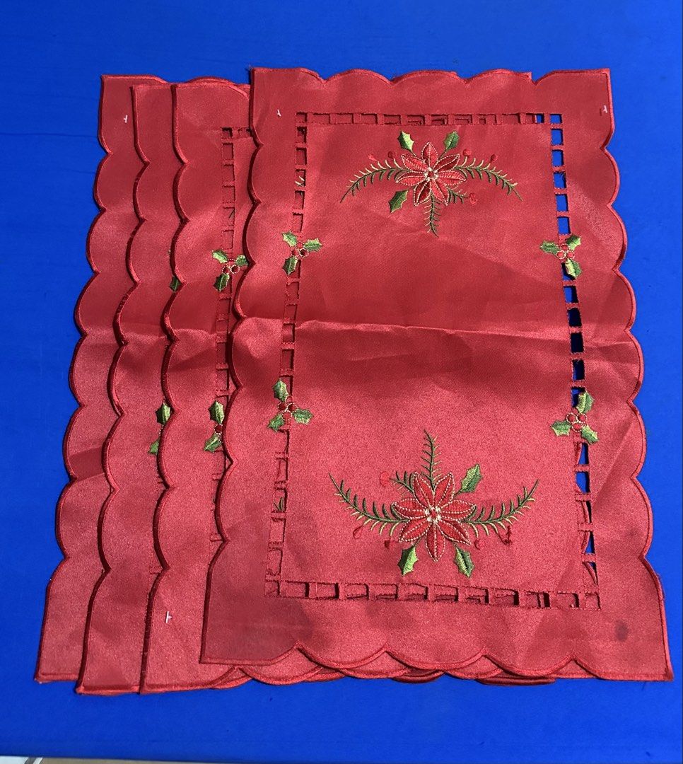 Christmas Red Placemats Set 4-pc (take all) (Category: Other Home Decor) located in Caloocan City. Submitted by bingluces (Listing ID 1438694987, Image 1). Description: - Set of red placemats - Scalloped edge design - Embroidered with poinsettias and holly - Festive Christmas theme - Made of a smooth, satin-like material .
