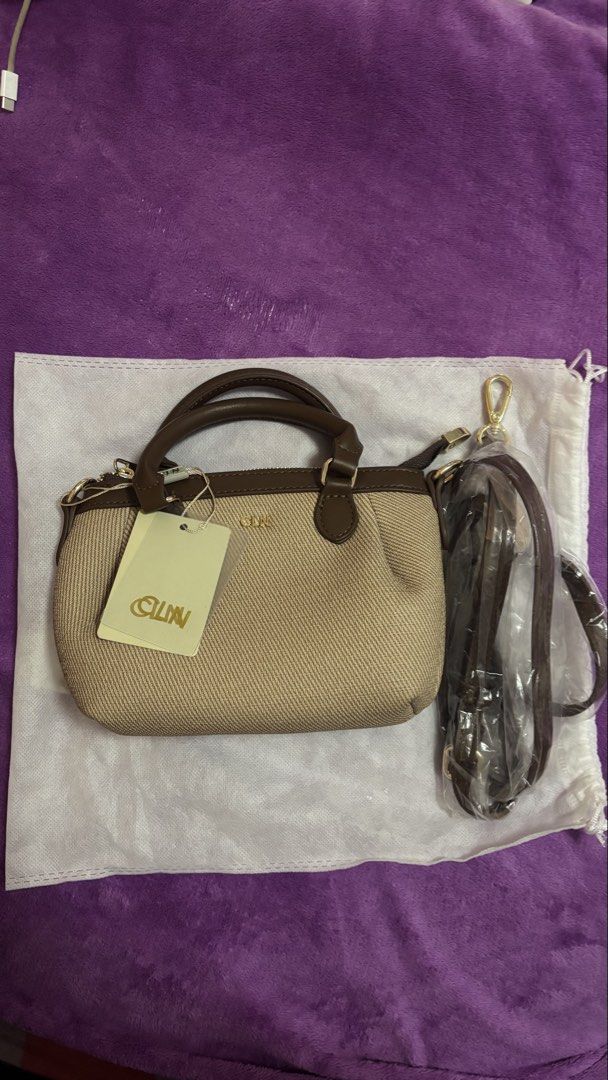 CLN Handbag with Shoulder Strap (Category: Shoulder Bags) located in Manila. Submitted by euriceabad45430 (Listing ID 1438797396, Image 2). Description: - CLN handbag - Brown and beige color - Detachable shoulder strap - Top handle - Zipper closure - Includes dust bag - CLN tag attached - Unused condition -No paperbag.