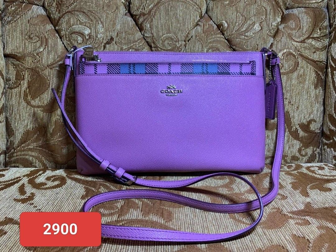 Coach Purple Crossbody Bag (Category: Cross-body Bags) located in Manila. Submitted by jiainah (Listing ID 1438764338, Image 1). Description: - Coach crossbody bag - Vibrant purple color with plaid accent - Includes long strap - Features Coach logo - Price: ₱2800.