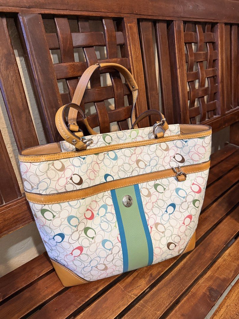 Coach Signature Tote Bag (Category: Luxury Bags & Wallets) located in Paranaque City. Submitted by declutterjunkie (Listing ID 1438805477, Image 1). Description: Coach signature tote bag with a colorful pattern. Features a light brown leather trim and handles. Includes a light brown interior lining. The bag has a vertical stripe design in the front with a Coach logo. Includes dust bag Loc: paranaque / can meet up in makati.