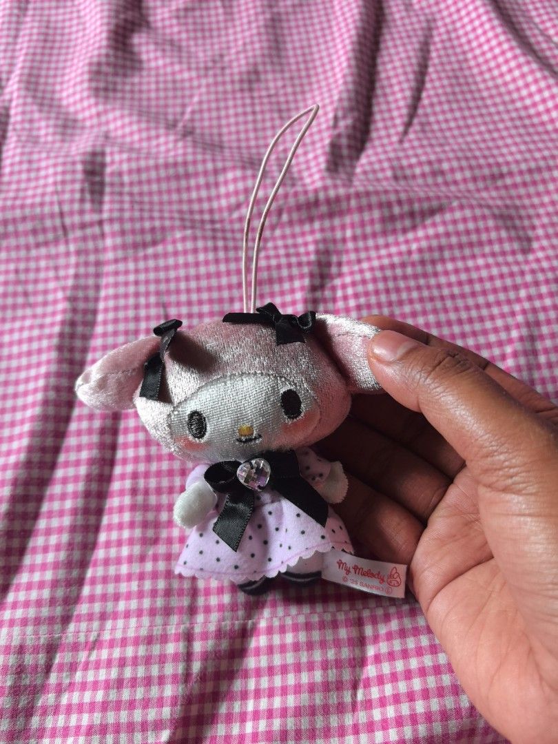 Collection My Melody Plushie Keychain (Category: Plushies & Soft Toys) located in Manila. Submitted by jhenniegir36703 (Listing ID 1438709143, Image 2). Description: - Adorable My Melody plushie keychain - Features a pink and white design - Includes a cute dress and black bow - Comes with a loop for easy attachment - Perfect for Sanrio character fans - Plushie has a tag attached.