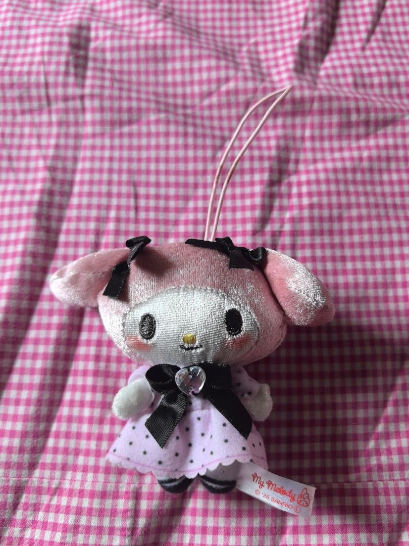 Collection My Melody Plushie Keychain (Category: Plushies & Soft Toys) located in Manila. Submitted by jhenniegir36703 (Listing ID 1438709143, Image 1). Description: - Adorable My Melody plushie keychain - Features a pink and white design - Includes a cute dress and black bow - Comes with a loop for easy attachment - Perfect for Sanrio character fans - Plushie has a tag attached.