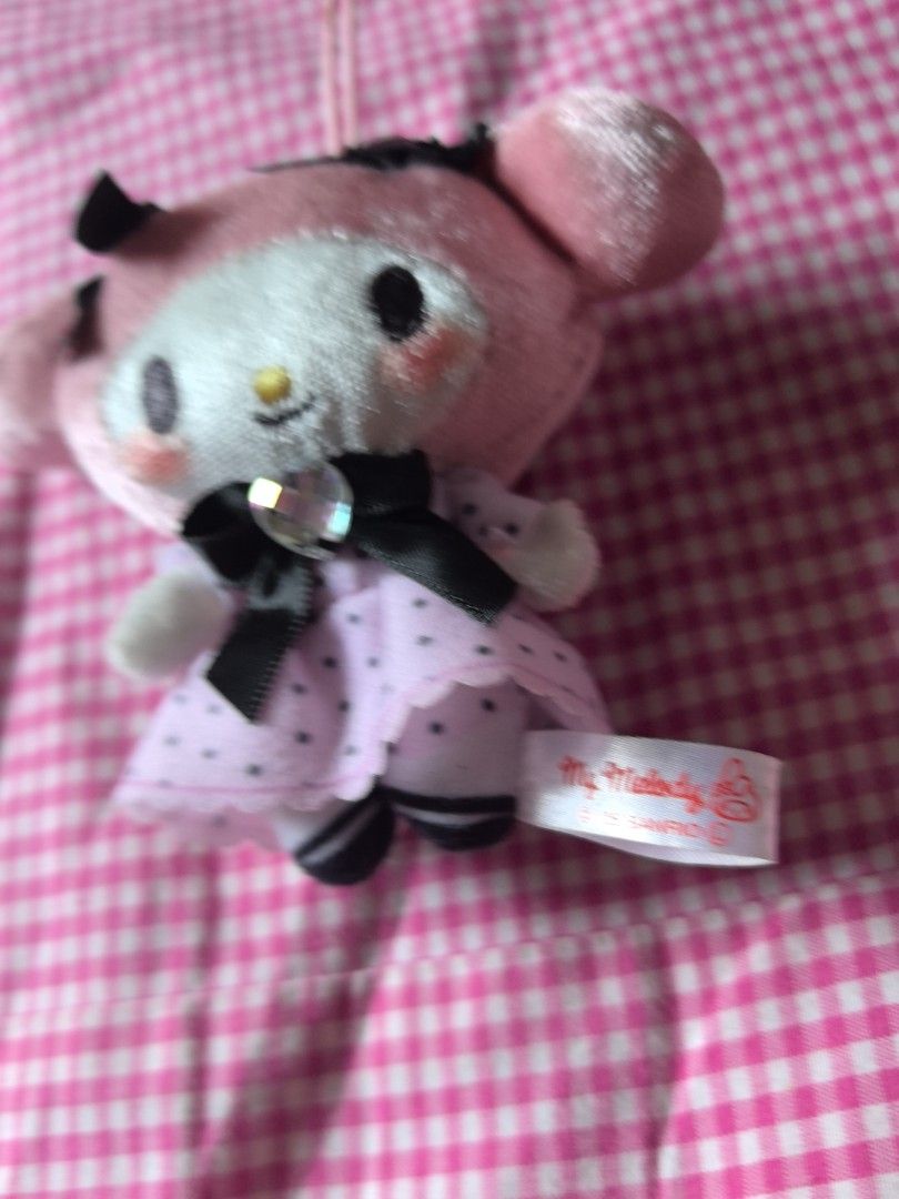 Collection My Melody Plushie Keychain (Category: Plushies & Soft Toys) located in Manila. Submitted by jhenniegir36703 (Listing ID 1438709143, Image 3). Description: - Adorable My Melody plushie keychain - Features a pink and white design - Includes a cute dress and black bow - Comes with a loop for easy attachment - Perfect for Sanrio character fans - Plushie has a tag attached.