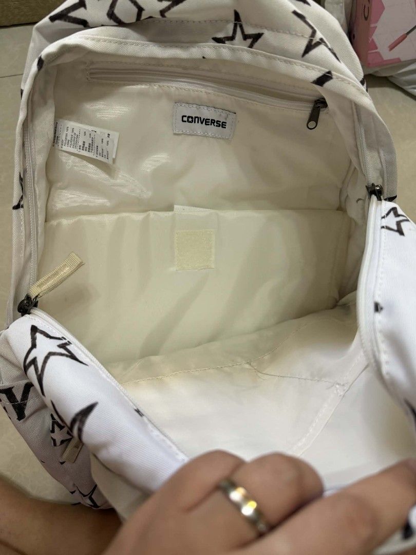 Converse Star Print Backpack (Category: Backpacks) located in Manila. Submitted by cosmicearth.d0c1a1 (Listing ID 1438769076, Image 2). Description: - authentic White Converse backpack with black star print - Main compartment for storage - Front pocket for easy access - Small interior pocket for valuables - Adjustable shoulder straps for a comfortable fit - Top handle for carrying - Features the iconic Converse logo delivery via lalamove courtesy