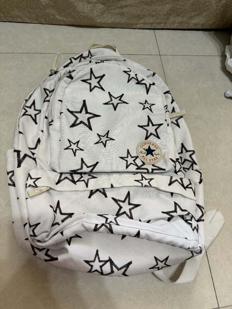 Converse Star Print Backpack (Category: Backpacks) located in Manila. Submitted by cosmicearth.d0c1a1 (Listing ID 1438769076, Image 1). Description: - authentic White Converse backpack with black star print - Main compartment for storage - Front pocket for easy access - Small interior pocket for valuables - Adjustable shoulder straps for a comfortable fit - Top handle for carrying - Features the iconic Converse logo delivery via lalamove courtesy