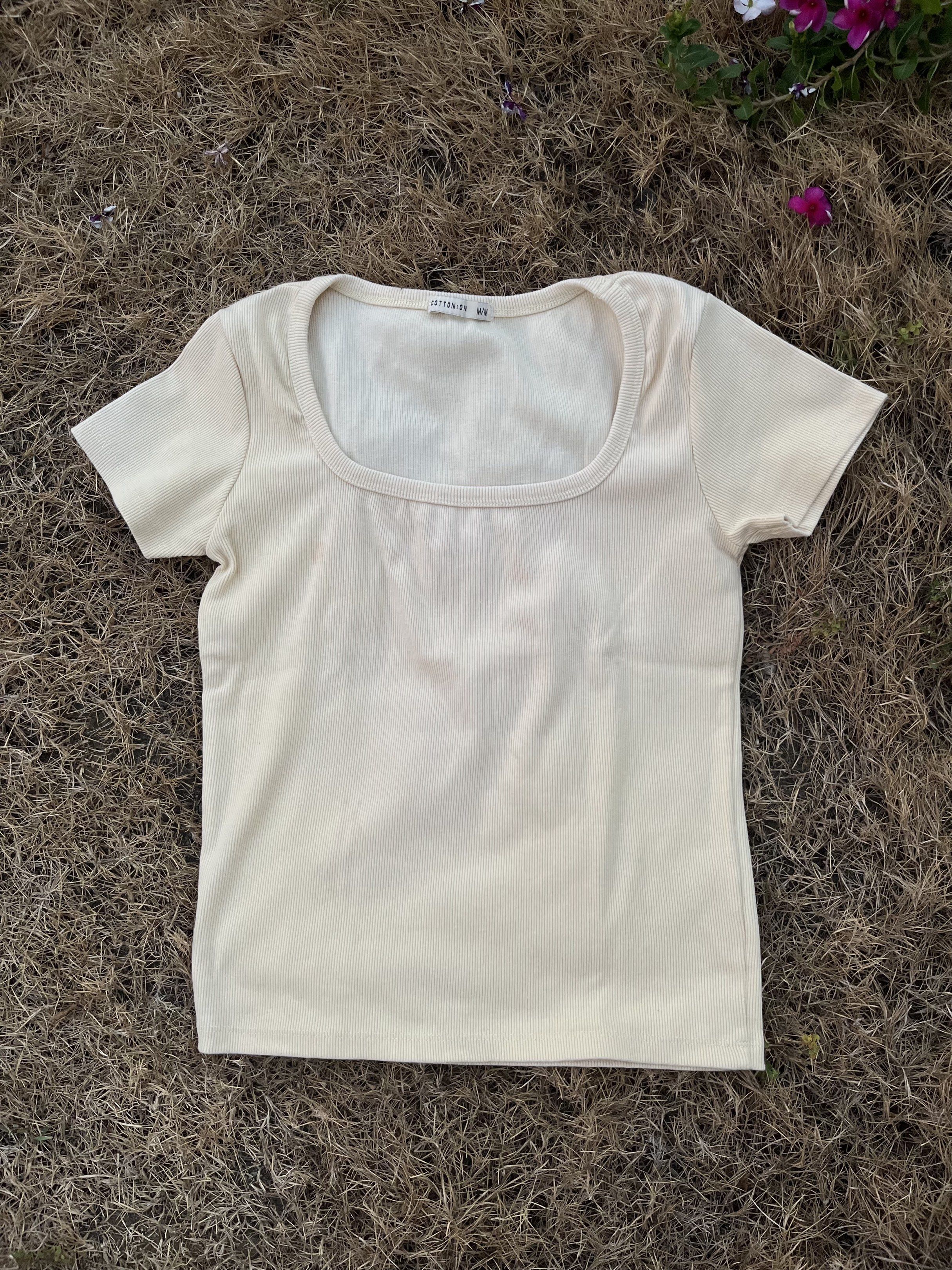 Cotton On Square Neck Ribbed Top (Category: Sleeveless) located in Manila. Submitted by kat_declutter (Listing ID 1438831918, Image 2). Description: - Cream-colored ribbed top from Cotton On - Features a square neckline - Short sleeves - Fitted style - Soft and comfortable fabric - Versatile for different outfits.