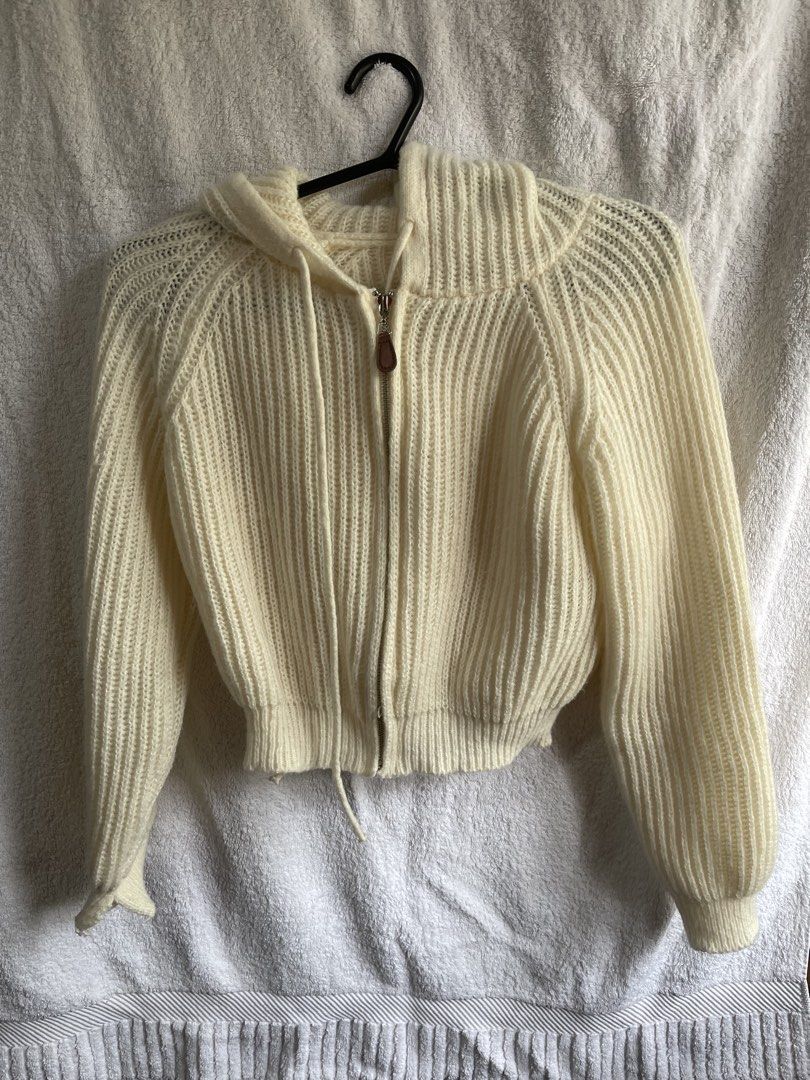 Cream Knitted Cropped Hoodie (Category: Coats, Jackets and Outerwear) located in Manila. Submitted by chogarcookie (Listing ID 1438753152, Image 1). Description: - Cream-colored cropped knitted hoodie - Zipper closure with brown leather pull - Hooded - Long sleeves with slight balloon shape - Ribbed texture - Drawstring at hem - Made of soft, warm material.