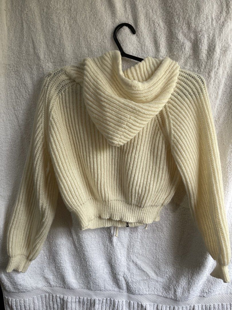 Cream Knitted Cropped Hoodie (Category: Coats, Jackets and Outerwear) located in Manila. Submitted by chogarcookie (Listing ID 1438753152, Image 2). Description: - Cream-colored cropped knitted hoodie - Zipper closure with brown leather pull - Hooded - Long sleeves with slight balloon shape - Ribbed texture - Drawstring at hem - Made of soft, warm material.