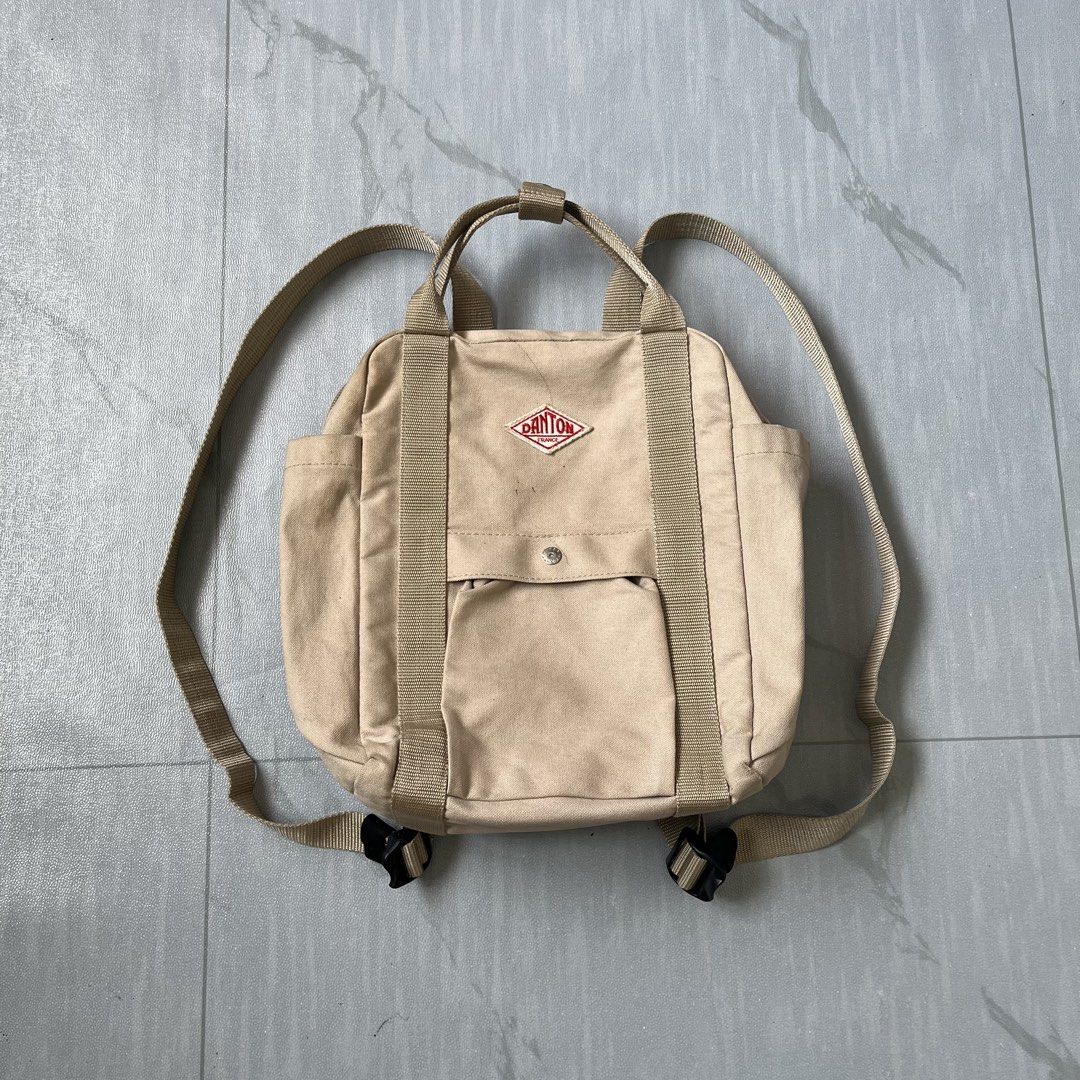 Danton 2-Way Mini Backpack Tote Bag (Authentic) (Category: Backpacks) located in Cavite. Submitted by newclassicwear (Listing ID 1438708324, Image 2). Description: Excellent Condition. None Any Issues Only Need Minor Wash. - Versatile Danton 2-way bag - Can be used as a tote or backpack - Features: - Front pocket with snap closure - Two side pockets - Top handle - Adjustable shoulder straps - Danton logo on the front - Neutral beige color.