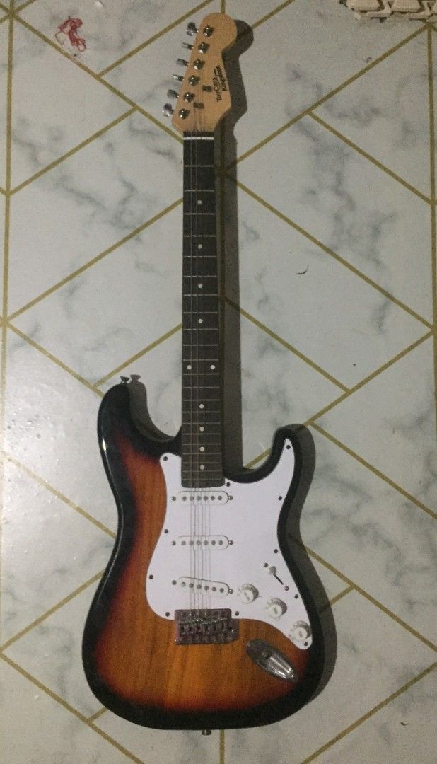 Electric Guitar Sunburst (Category: Musical Instruments) located in Lucena. Submitted by sorreennn (Listing ID 1438799601, Image 1). Description: - Sunburst electric guitar - White pickguard - Classic Stratocaster body shape - Three single-coil pickups - Tremolo bridge - Maple neck with dot inlays - Three-tone sunburst finish - Brand name on headstock rfs switched to the bass badly need funds.