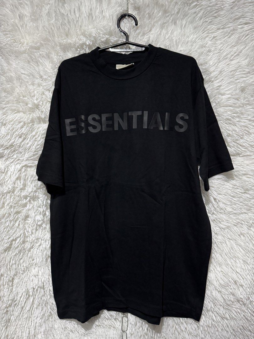 Fear of God Essentials Black Tee (Category: Tshirts & Polo Shirts ) located in Naguilian. Submitted by joeogoc09-21578 (Listing ID 1438696425, Image 1). Description: - Black t-shirt - Features "ESSENTIALS" print on chest - Classic crew neck - Short sleeves - Made from soft fabric.