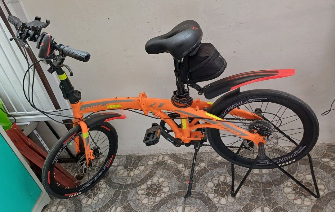 Trinx Dolphin 2.0 Foldable Bike (Category: Bicycles) located in Bacoor. Submitted by ricks01 (Listing ID 1438811637, Image 1). Description: - Trinx Dolphine 2.0 foldable bike - Black tires and disc brakes. Black seat with storage bag - Front and rear fenders. Handlebars with phone mount - Bike stand included - Some scratches and stains due to wear and tear..