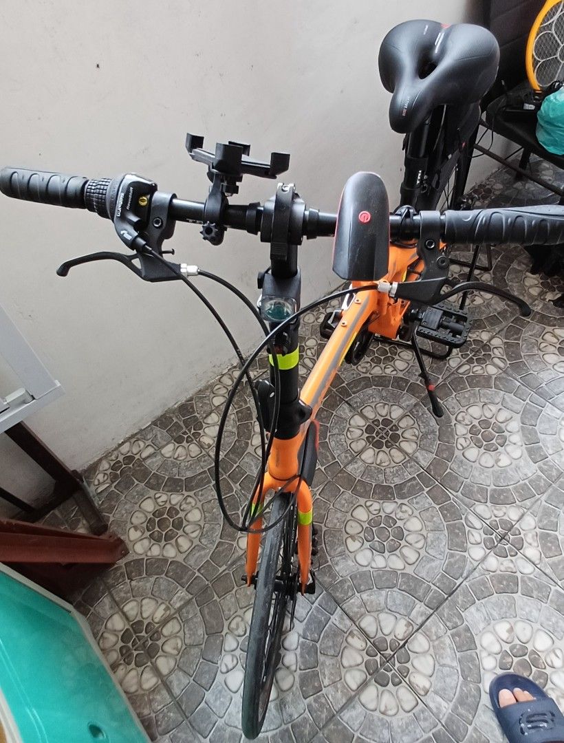Trinx Dolphin 2.0 Foldable Bike (Category: Bicycles) located in Bacoor. Submitted by ricks01 (Listing ID 1438811637, Image 3). Description: - Trinx Dolphine 2.0 foldable bike - Black tires and disc brakes. Black seat with storage bag - Front and rear fenders. Handlebars with phone mount - Bike stand included - Some scratches and stains due to wear and tear..