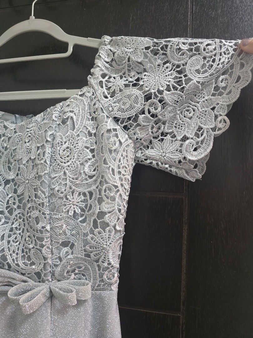 Formal Silver Lace Dress - Size M (Category: Dresses) located in Quezon City. Submitted by ohmystones_088 (Listing ID 1438811859, Image 3). Description: - Silver lace dress - Size M - Bust 34, Waist 28 - Intricate lace detailing on bodice and sleeves - Flattering silhouette with pleated design - Zipper closure at the back - Shiny material - Free Brooch and accessories - Only used once 😊wyswyg 😊 💕Due to the light and screen setting difference, 